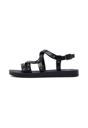 Sandalo nero con più cinturini decorati con borchie metalliche, suola piatta e fibbia regolabile per una vestibilità ottimale.