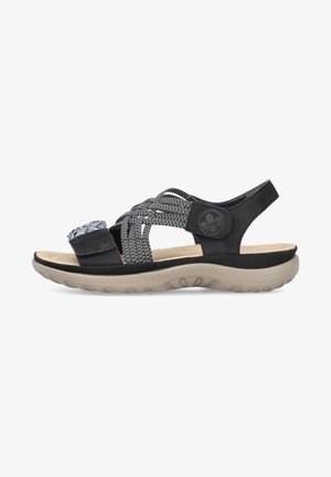Zwarte sandaal met gevlochten elastische bandjes, een stoffen accent, een gevoerd inlegzool en een gevormde tan rubberen zool, ontworpen voor comfort en ondersteuning.