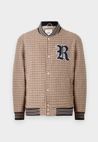 Brun houndstooth-mønstret bomberjakke med marineblå ribbestrikket krage og mansjetter. Har et 'R'-logo-patch og trykknapåpning.