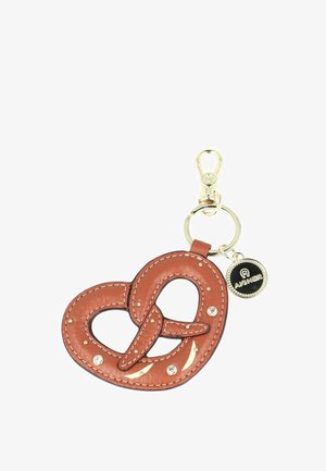 Brown leather pretzel-shaped keychain with gold studs, rhinestones, a gold clasp, and a small round black and gold Aigner logo tag.