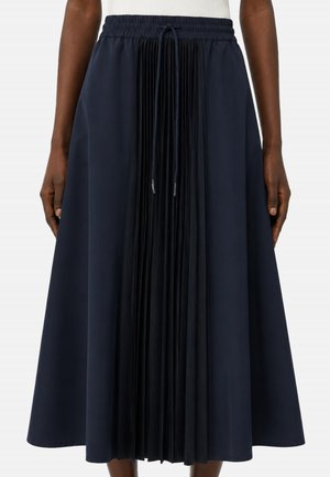 Gonna midi blu navy con fascia elastica in vita, coulisse regolabile e pannello centrale plissettato, indossata da persona con carnagione scura.