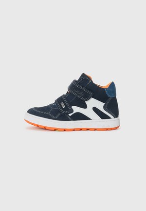 Blue suede high-top sneaker with orange sole, white accents, and two Velcro straps. Features a padded collar and stitched detailing.