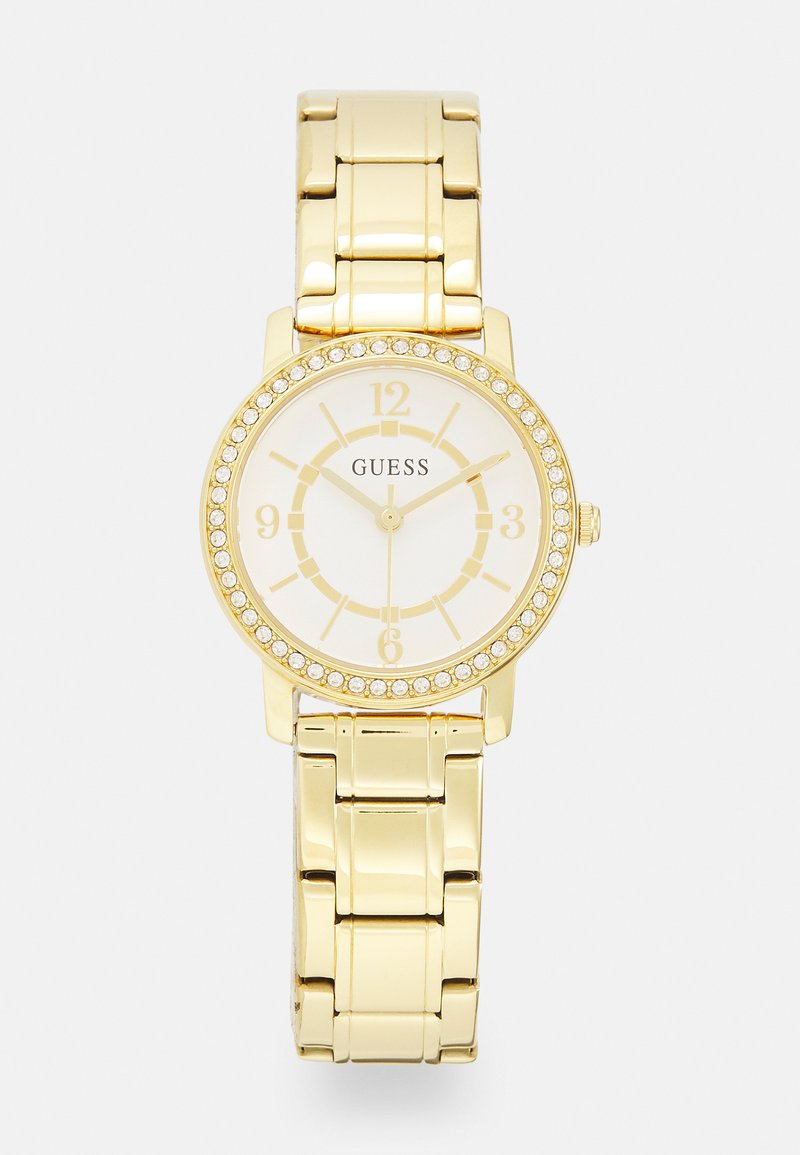 Gold-tone wristwatch with a round case, white dial, gold hour markers, and a bezel adorned with clear crystals. Metal bracelet style band.