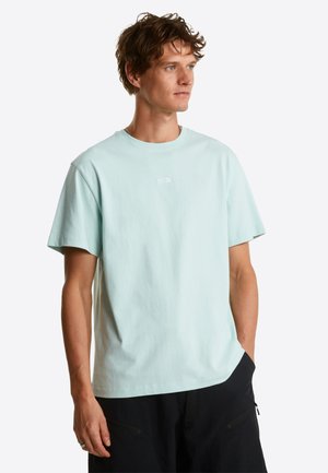 Lyse grøn bomulds-T-shirt med korte ærmer og rund hals; har en lille hvid logo på brystet. Enkel, afslappet pasform.