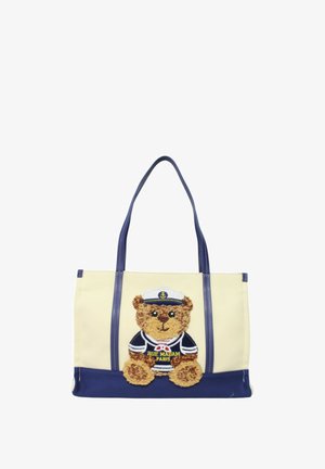 Borsa a tracolla beige e blu navy con manici blu, raffigurante un orsetto con indosso un cappello da marinaio e una maglietta ricamata con la scritta "Rue Madam Paris".