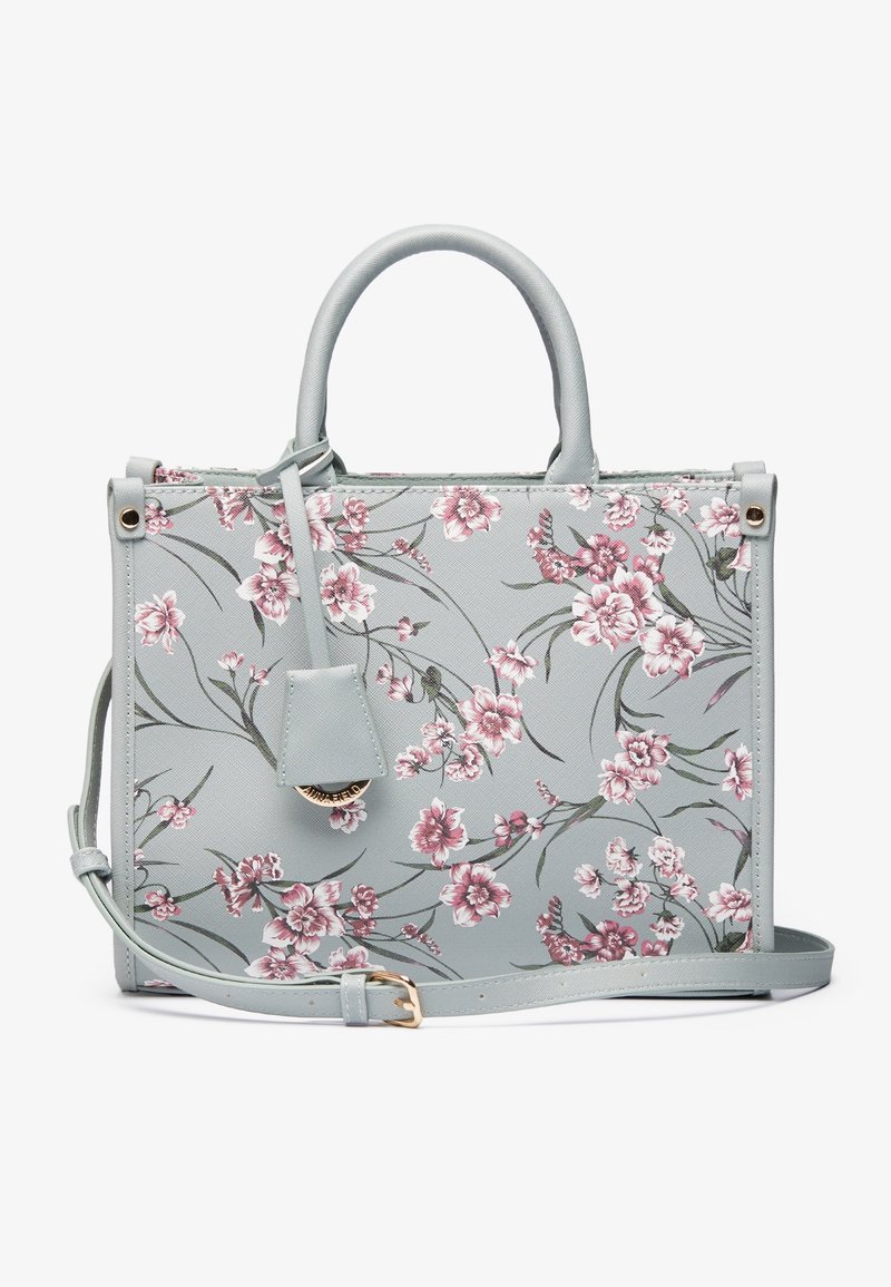 Sac à main gris clair avec imprimé floral rose et blanc, doubles poignées et bandoulière ajustable avec boucle dorée.