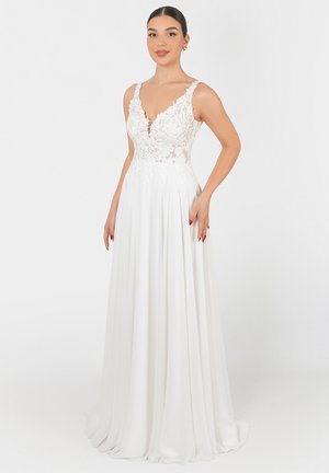 Weißes Kleid mit einem enganliegenden Oberteil, das mit floralen Spitzenakzenten verziert ist, und einem tiefen V-Ausschnitt. Fließender A-Linien Rock aus glattem Stoff.