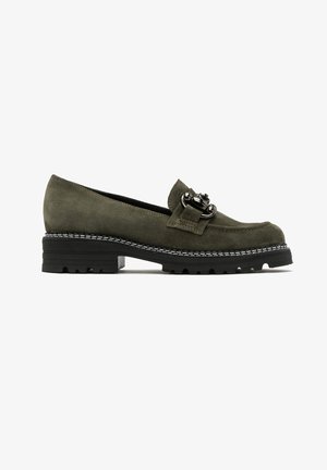 Mocassins en suede vert avec une boucle décorative, dotés d'une semelle en caoutchouc noir et de détails blancs cousus. Design classique et talon bas.