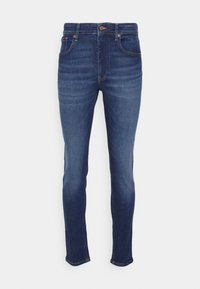 Úzké džíny vyrobené z tmavě modrého denim. Mezi funkce patří zapínání na knoflík, pět kapes a jemné vyblednutí na stehnech.