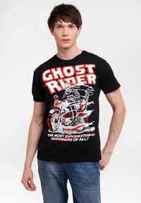 Black T-shirt featuring a colorful "Ghost Rider" graphic with a skull character on a motorcycle. Text in bold red and white below the image.