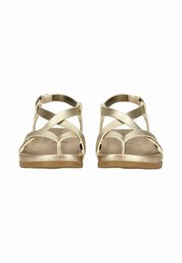 Zlaté metalické sandály na tenké pásky s křížovým designem, plochou podrážkou a přezkovým páskem kolem kotníku. Hladký povrch s minimalistickou estetikou.