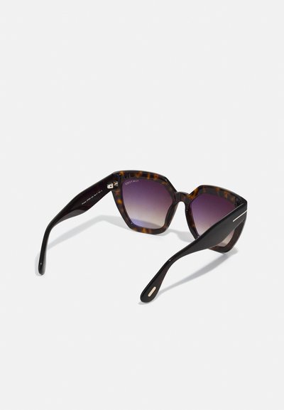 Hexagonal sunglasses with a tortoiseshell pattern, dark lenses transitioning to purple, black temples with metallic accents.