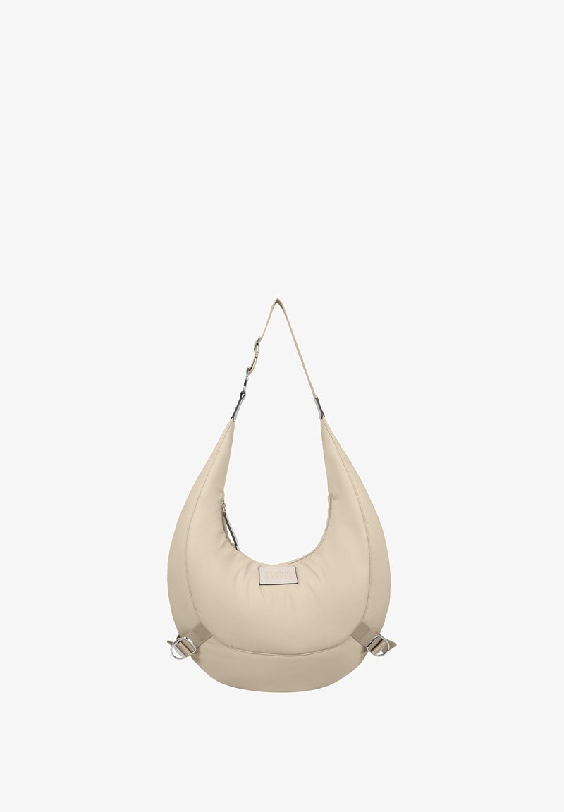 Beige, padded hobo bag with an oversized shape. Features a shoulder strap, side buckles, and a front logo patch. Smooth texture.