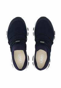 Navy knit athletic shoes with a stretchy upper, black elastic laces, and a white outsole. Soft, textured interior lining and logo detail.
