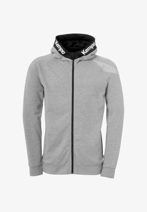 Grijze zip-up hoodie van zachte stof, met een zwart voorgevormde capuchon, witte "Kempa" branding op de kraag en textuuraccenten op de schouders.