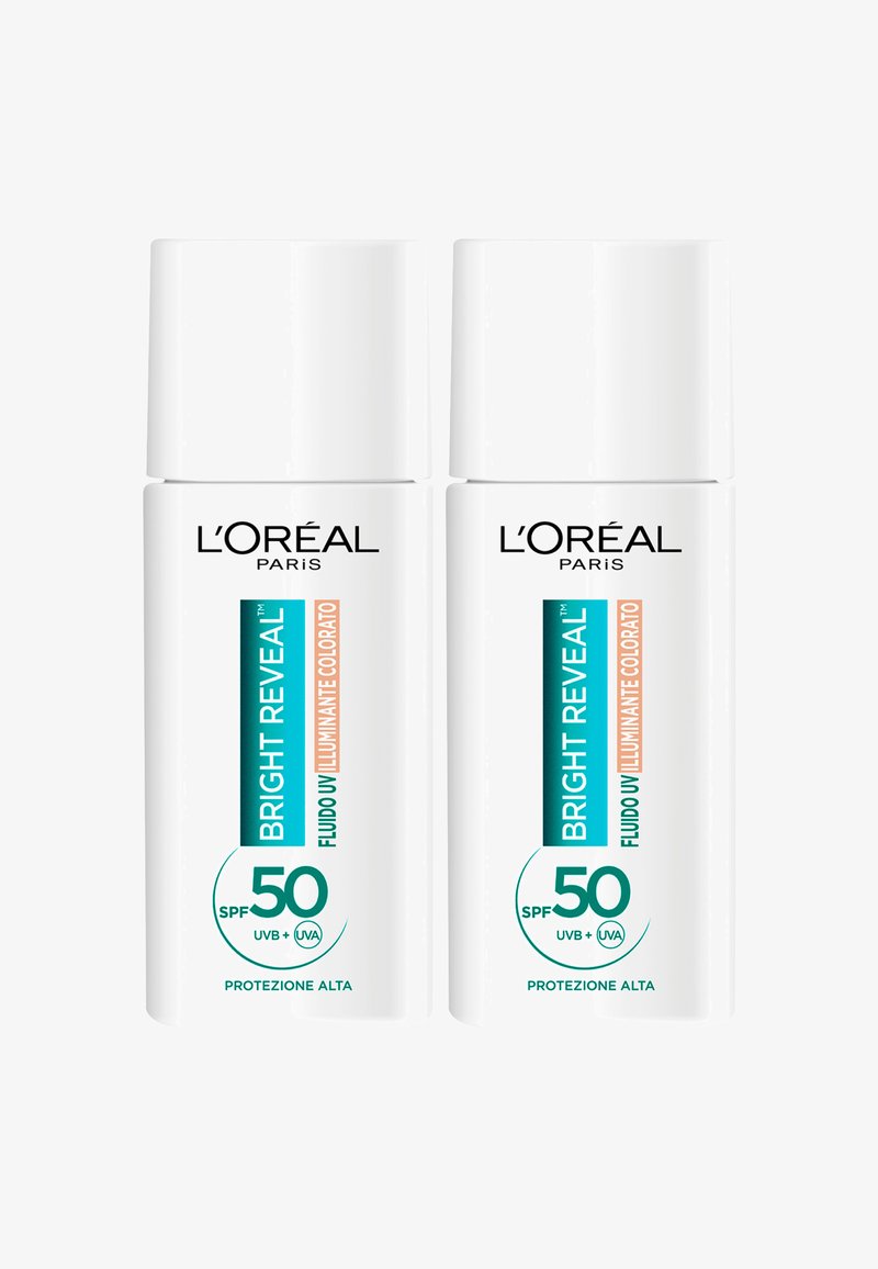 Coppia di bottiglie di sole bianche etichettate "Bright Reveal," SPF 50, con testo nero e turchese, superficie liscia e tappi arrotondati.