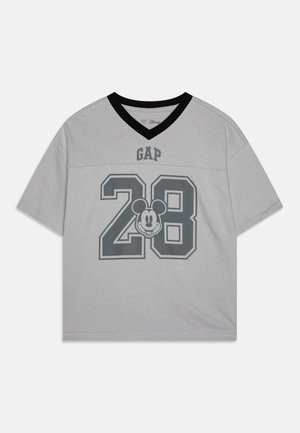 T-shirt gris à manches courtes en coton avec un col en V noir. Il présente un logo "GAP" gris et un grand "28" avec un graphique de Mickey Mouse.
