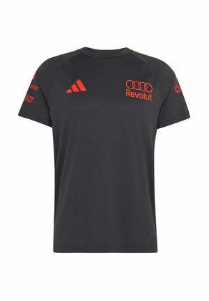 Camiseta deportiva negra con logo de Adidas rojo en el pecho, logos de Revolut y Audi en el frente, y logos de patrocinadores en ambas mangas.