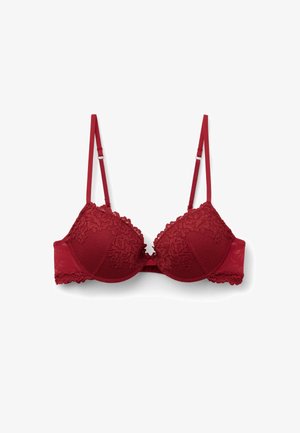 Bra rosso con rifiniture in pizzo, coppe imbottite e un design texturizzato. Spalline regolabili e una banda posteriore liscia per supporto.