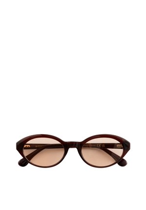 Lunettes de soleil ovales marron avec verres ambre translucides et monture brillante marron foncé, branches pliées visibles derrière les verres.