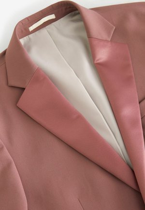 Rostfarbener Blazer mit glatter Textur, ausgestattet mit einem satinartigen Revers und creamfarbiger Fütterung. Einfaches Design ohne sichtbare Muster oder Beschläge.
