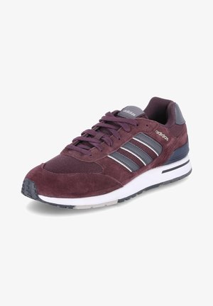 Baskets Adidas bordeaux avec tige en daim et en mesh, trois bandes grises, fermeture à lacets, et semelle blanche amortie avec des accents noirs.