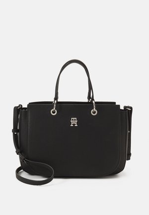 Schwarze Lederhandtasche mit strukturiertem Finish, silberner Hardware, doppelten oberen Tragegriffen, abnehmbarem Schultergurt und eingeprägtem Logo auf der Vorderseite.