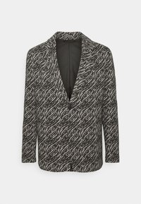 Blazer bianco e nero con motivo a onde, maniche lunghe, rever a lancia, chiusura con un bottone e una texture in tessuto liscia.