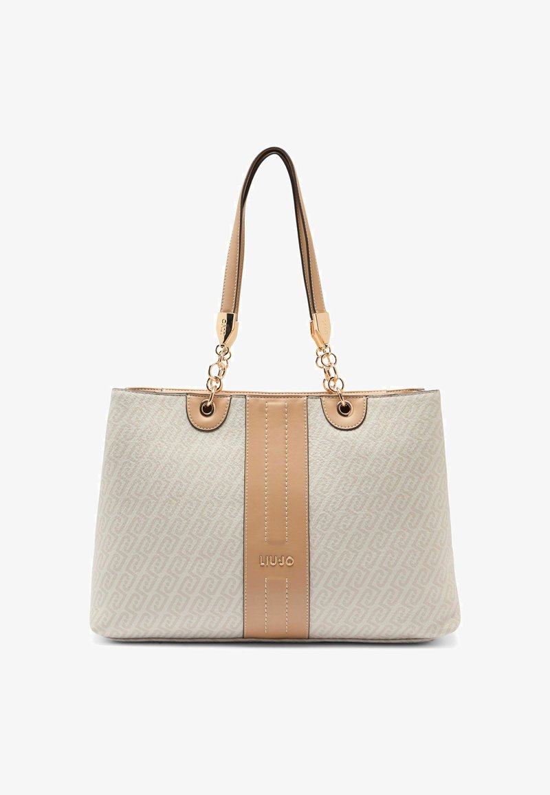 Sac fourre-tout en tissu beige avec chaînes dorées, présentant une bande centrale beige et un motif géométrique. Logo de la marque embossé à l'avant.
