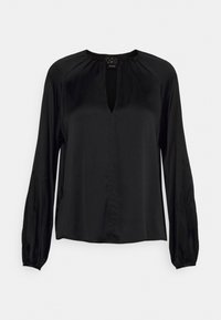 Blusa nera a maniche lunghe con scollatura rotonda e dettaglio a chiave sul davanti, vestibilità ampia, polsini arricciati e leggera lucentezza del tessuto.