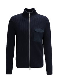 Granatowy prążkowany sweter na zamek z wysokim kołnierzem, z lewej strony na piersi kieszeń z gładkiej tkaniny, srebrny zamek błyskawiczny i strukturalny splot.