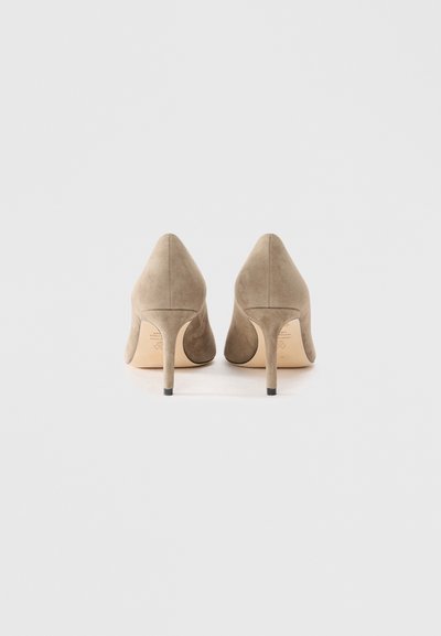 Beige suede high-heeled shoes with pointed toes and a stiletto heel, featuring a smooth texture and minimal design.