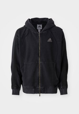 Black Adidas zip-up hoodie with hood, front pockets, three stripes on sleeves, and Adidas logo on left chest.