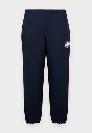 Pantaloni de trening bleumarin din bumbac moale, cu manșete elastice și talie elastică. Prezintă un logo alb Lacoste Paris pe piciorul stâng.