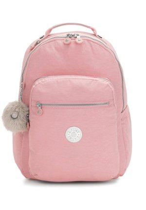Pink nylon backpack with a rounded shape, featuring a front pocket, zipper closures, and a fur pom-pom accent. Circular logo on front.