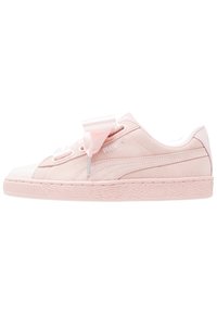 Růžové semišové tenisky s polstrovaným límcem, saténovými tkaničkami, texturovanou gumovou podrážkou a embosovaným logem. Klasický nízkoprofilový design.