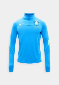 Haut d'entraînement de football du Brésil bleu à manches longues avec demi-fermeture éclair, logo Nike jaune et écusson CBF du Brésil sur la poitrine.