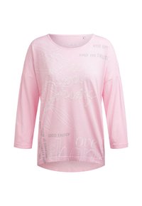 Light pink long-sleeve shirt with round neck, featuring white and gray inspirational text and floral line art on the front.