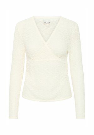 Valge pitsiline topp V-kaelusega ja pikkade varrukatega. Omab mähisvalikut ja tekstuurset lillemustrid. Õrn ääris allääres ja varrukatel.