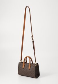 Sac à main marron à motifs avec une forme structurée, doté de deux poignées supérieures et d'une sangle d'épaule amovible en cuir tan. Détails en métal doré.