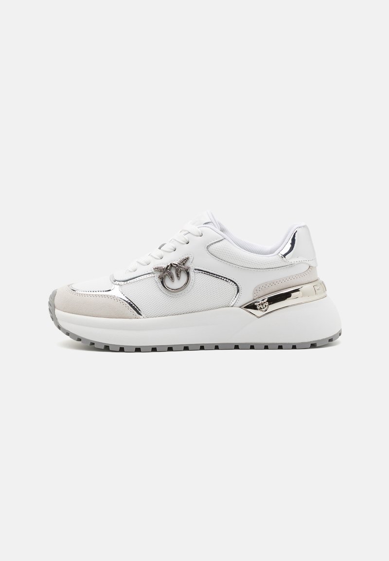 White athletic sneakers with textured mesh and suede accents, metallic details, logo embellishment, and a thick white outsole.