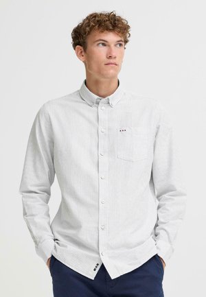 Striped button-up shirt in light gray fabric with a chest pocket. Features a casual collar and curved hem. Visible logo accents near hem.