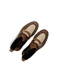 Brown suede loafers with a smooth leather strap, gold buckle accent, and textured cream panel. Stitch detailing around the sole.