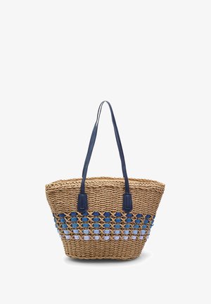 Sac fourre-tout en paille tissée avec des poignées en cuir bleu marine, présentant un design motif en bleu marine, bleu et bleu clair en bas.