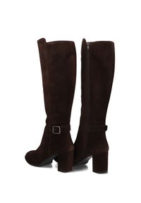 Brown suede knee-high boots with a block heel, side zipper, and a strap detail with a buckle at the ankle, featuring a smooth texture.