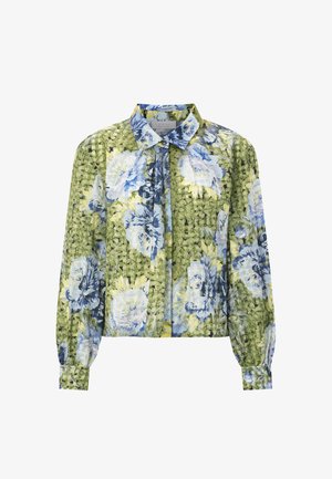 Lilleline pluus rohekat taustaga, millel on sinised ja kollased lillemustrid, pikad varrukad ning nööpidega kaelasäär. Kortsuline tekstuur.