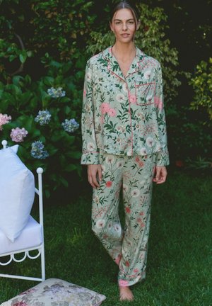 Floral-patterned pajamas in light green, featuring pink accents. Long sleeves, button-up top with pocket, and matching pants with elastic cuffs.