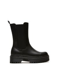 Black ankle boots made of leather and elastic, featuring a chunky treaded sole and side panels, with a loop tab for easy wear.