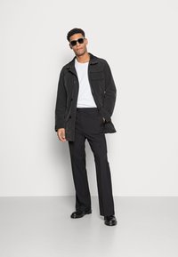 Weekday FRANKLIN FLARED TROUSERS - Calças - black
