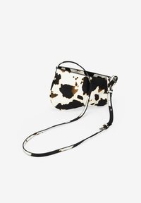 Bolso de hombro con estampado de piel de vaca en blanco y negro, con un diseño sin costuras, correa ajustable y textura suave. Cuenta con un cierre con cremallera.